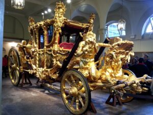 Gold Processional State Carriage at the Royal Mews, Buckingham Palace London. Photo by Aurelie.