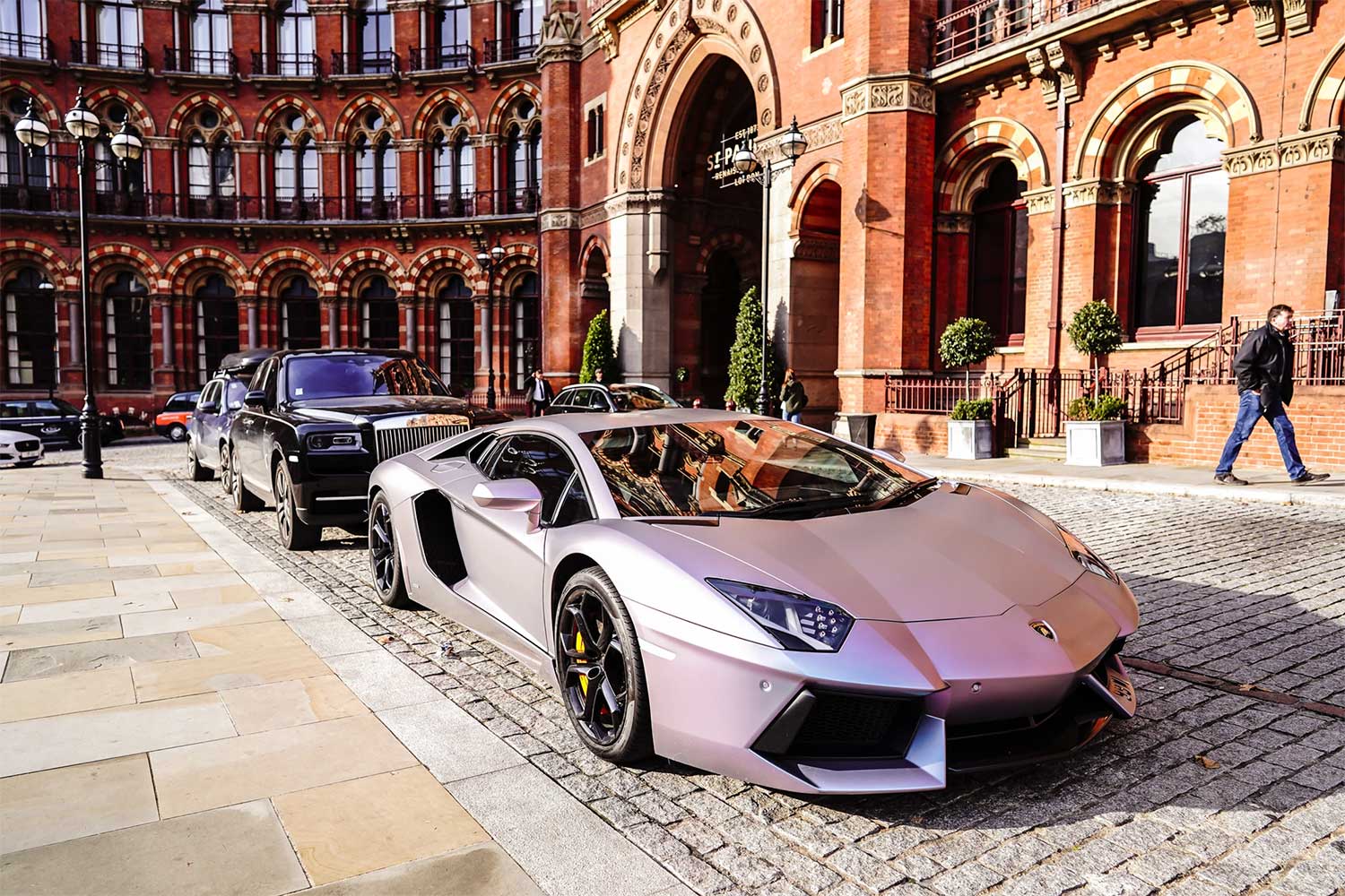 Luxury cars outside the equally luxurious St Pancras Renaissance Hotel