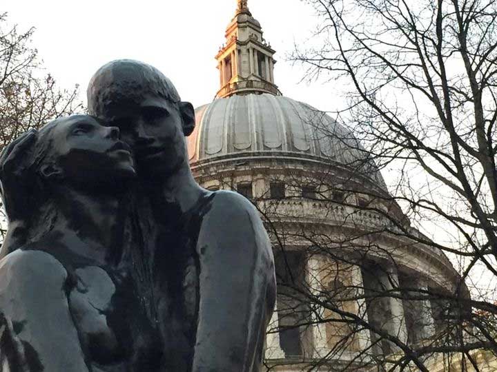 Statues in the foreground of Saint Paul's Cathedral and trees make for a romantic setting.