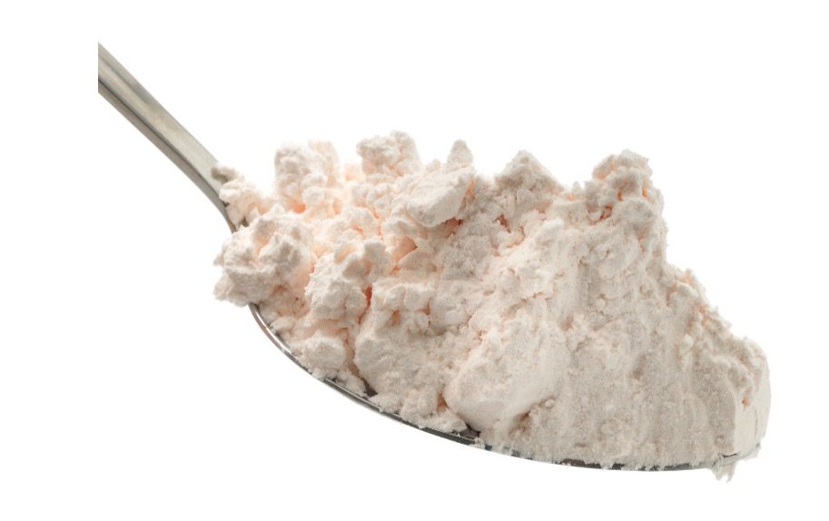 Custard powder is mixed with milk to form a pudding sauce.