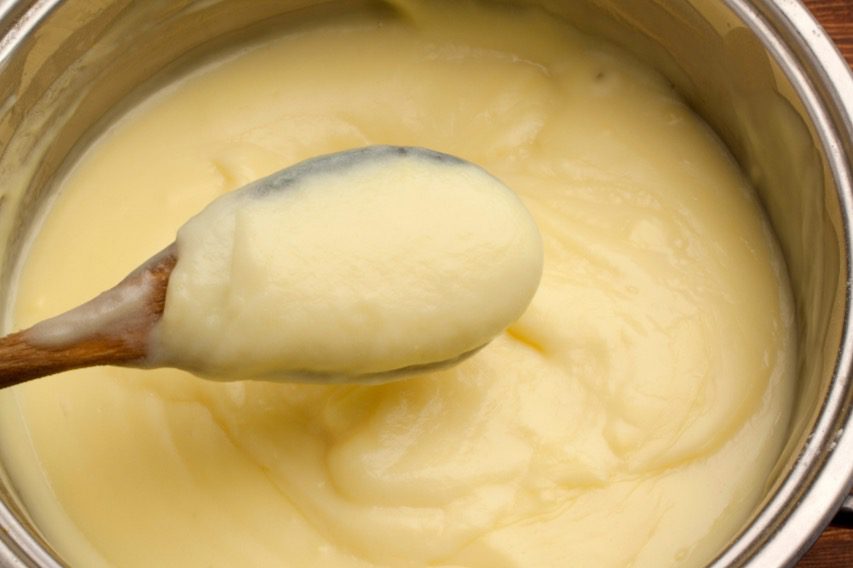 Custard is heated in a saucepan until it is thick. 