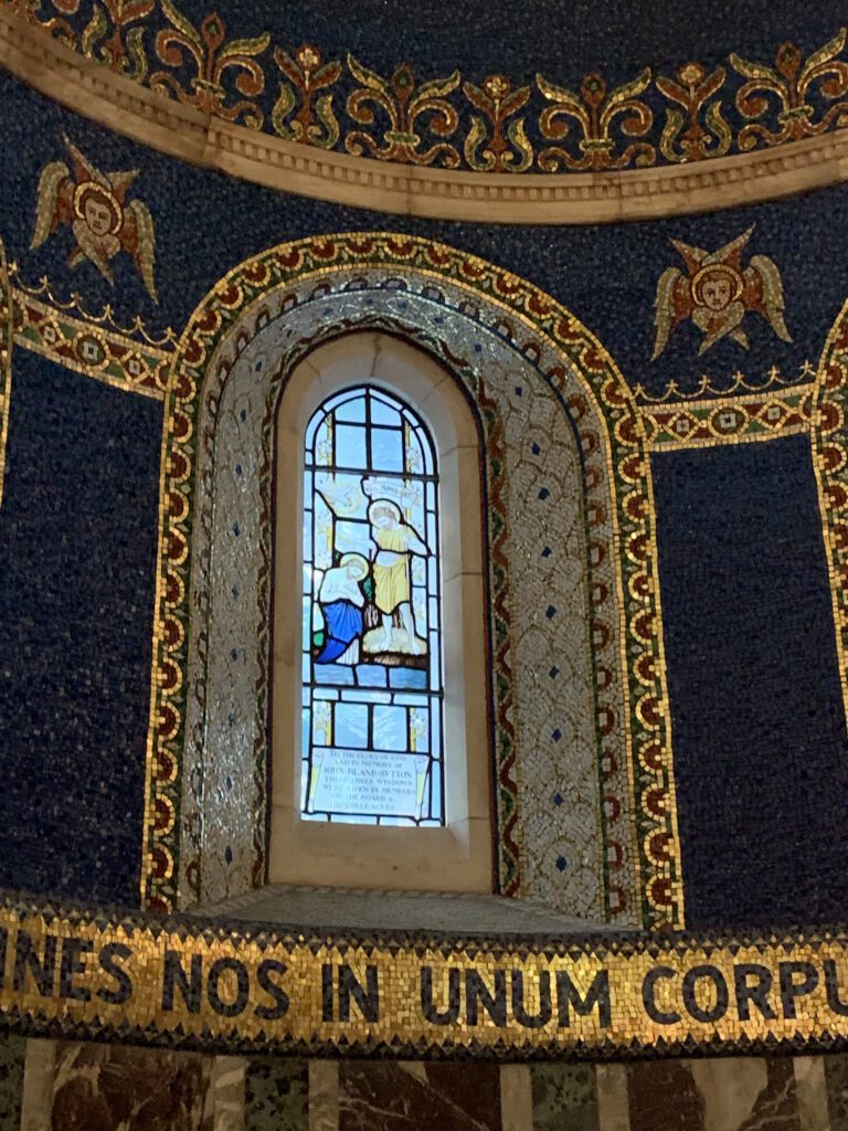 The stained glass windows in the baptistery.