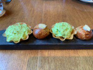Complimentary canapés of cheese gougere and smoked salmon and avocado mousse tart.